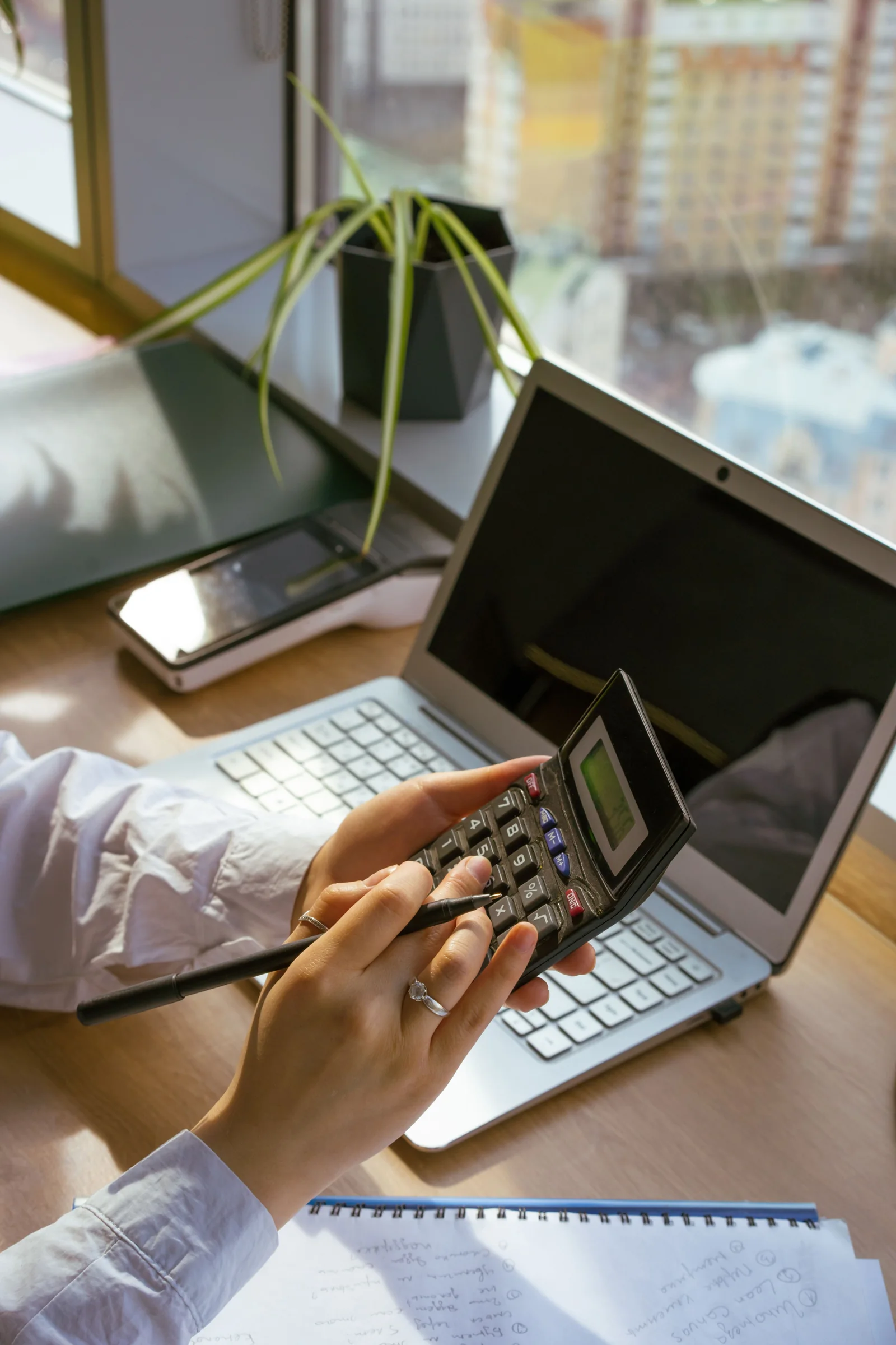Commerce study with calculator, laptop and notes